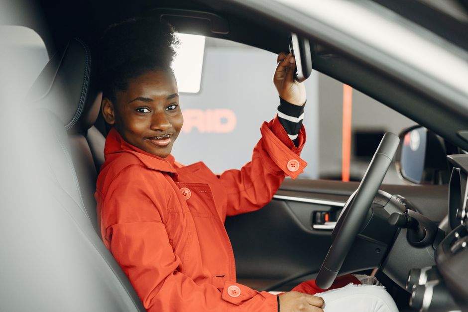 Smiling auto detailer providing premium car wash services
